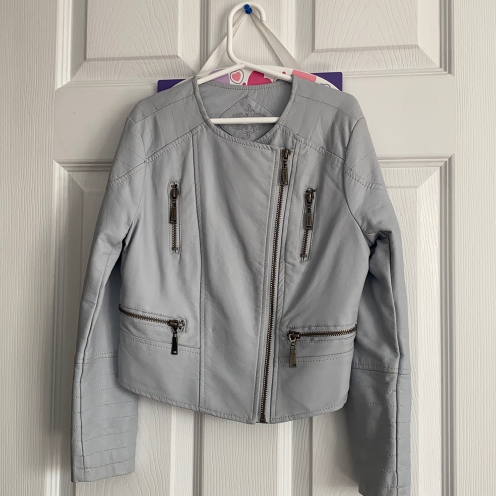 A girls leather jacket with five zippers